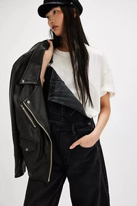 Detail of vintage washed black denim overalls with adjustable straps and high-quality texture