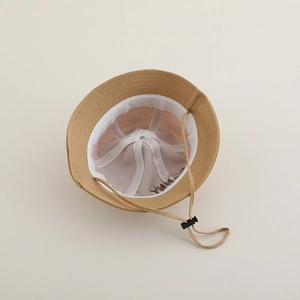 Detail view of khaki bucket hat interior with breathable lining and adjustable wind rope