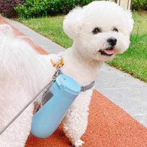 Portable pet water bottle with foldable lid for dogs in outdoor travel scenery