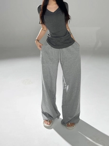 Women's slim fit V-neck grey short sleeve t-shirt paired with casual wide leg lounge pants