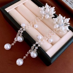 Detail of long fringe pearl earrings with crystal beads and gold plating in a gift box