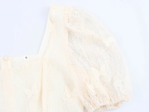 Close-up of square neck lace top with 3D butterfly floral appliques and puff sleeves
