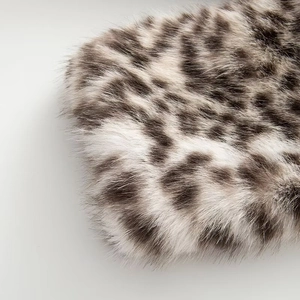 Macro shot of high-quality leopard print faux fur texture with soft plush animal pattern