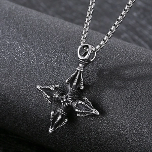 Macro shot of silver titanium steel vajra cross pendant with durable box chain link