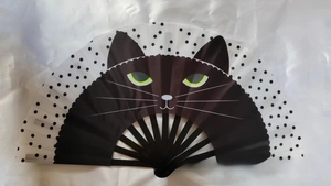 Close-up of a foldable fan featuring a cute black cat pattern and stylish polka dots