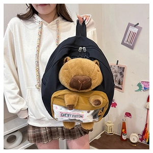 Detail of black capybara backpack with 3D plush doll and transparent PVC zip pocket