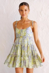 Close-up of floral tiered sundress featuring adjustable spaghetti straps and layered ruffle hem