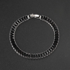 Close-up of black rectangular cubic zirconia tennis bracelet with silver metal fold-over clasp
