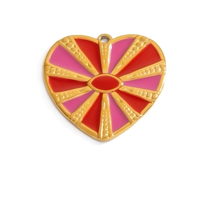 Macro detail of heart-shaped gold-plated pendant with red and pink enamel textures