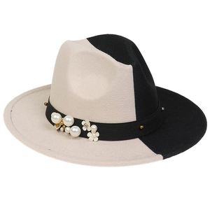 Detail of black and white gradient fedora hat with white pearl and floral decorative band