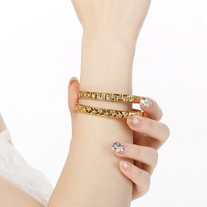 Detail of 18K gold plated bangles featuring geometric patterns and sparkling rhinestones