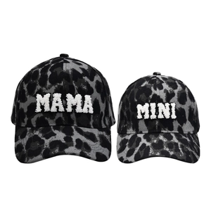 Detail of leopard print baseball caps with MAMA and MINI white chenille embroidery
