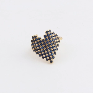 Detailed macro of gold heart ring with blue zircon stones and pixelated edges