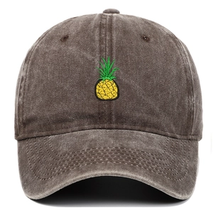 Detailed view of yellow pineapple embroidery on vintage washed cotton baseball cap