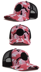 Detail view of pink camouflage trucker hat with mesh back and circular brand patch
