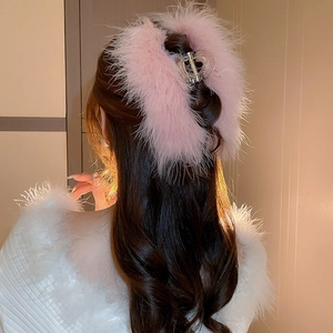 Detail of pink faux fur hair claw clip showing soft texture on back of head
