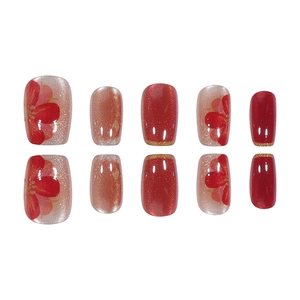 Red cat eye press-on nails with golden glitter and delicate hand-painted floral art