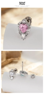 Detailed macro view of heart-shaped zircon earrings with baroque scroll engraving and screw back