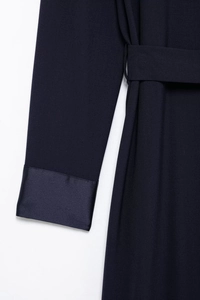 Detail of dark blue cargo dress featuring epaulettes, belted waist and spliced cuffs