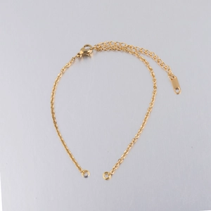 Close-up of a 2mm gold stainless steel link chain bracelet with lobster clasp and extender