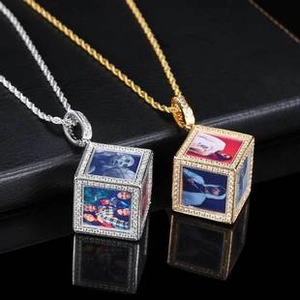 Close-up of gold and silver cubic zirconia cross pendants with photo customization detail