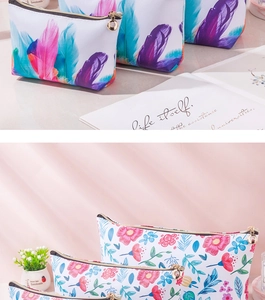 Detailed view of floral PU makeup bags with gold zippers on a soft pink background