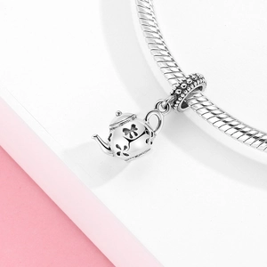 S925 sterling silver teapot charm with hollow patterns on a textured chain bracelet