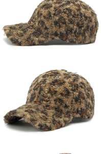 Detailed close-up of leopard print teddy fleece texture on the winter baseball cap