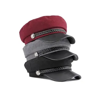 Woolen baker boy hats in burgundy, gray and black with leather brims and metal buttons