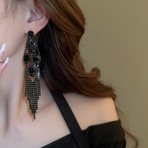 Close-up of black rhinestone water drop tassel earrings with long dangling crystal chains