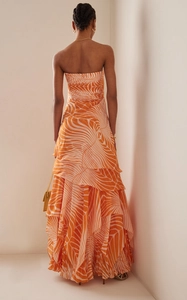 Detail of layered orange leaf print tiered strapless maxi dress with textured fabric