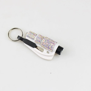 Close-up of mini 2-in-1 car window breaker with rainbow rhinestones and keychain