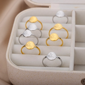 Minimalist 18K gold and silver stainless steel sun moon rings in a beige jewelry box
