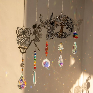 Crystal suncatcher set with owl and hummingbird metal charms casting rainbow light