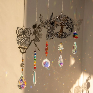 Crystal suncatcher set with owl and hummingbird metal charms casting rainbow light