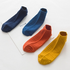Set of four breathable cotton low-cut ankle socks in vibrant navy, blue, orange, and yellow