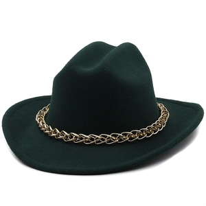 Close-up of dark green wool fedora hat featuring a bold gold chain band detail