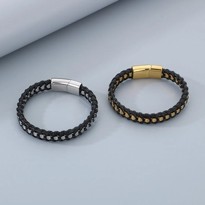 Detail of woven leather bracelets with magnetic clasps in gold and silver finish
