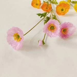 Top view of colorful artificial poppy flowers in pink, yellow, and orange with green stems