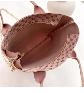 Interior view of pink plaid satchel showing main pocket, metal chain, and floral pattern