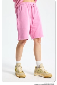 Close-up of pink cotton shorts with elastic drawstring waist and side pockets