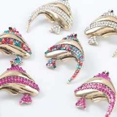 Detailed macro view of colorful rhinestone-encrusted dolphin jewelry accessories