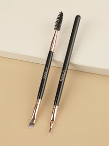 Detailed view of dual-ended eyebrow and eyeliner brushes with rose gold ferrules