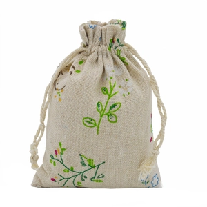 Close-up of floral print cotton linen drawstring bag showing texture and green leaves