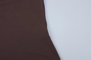 Macro view of dark brown knit fabric texture for this two-piece summer skirt set