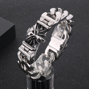Detailed close-up of a silver 316L stainless steel bracelet with an engraved wolf head