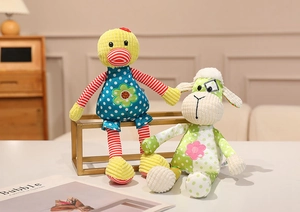 Close-up of plush duck and sheep toys featuring striped fabric and floral details
