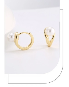 Detailed close-up of 14K gold plated silver hoop earrings with white round shell pearls