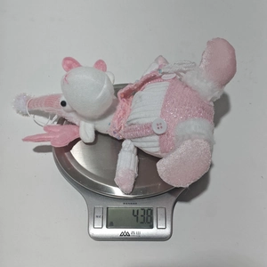Pink sequin plush Christmas doll with wings on a scale showing 43.8g weight