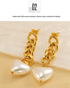 Detail of 18K gold-plated chain earrings featuring a polished white resin heart drop